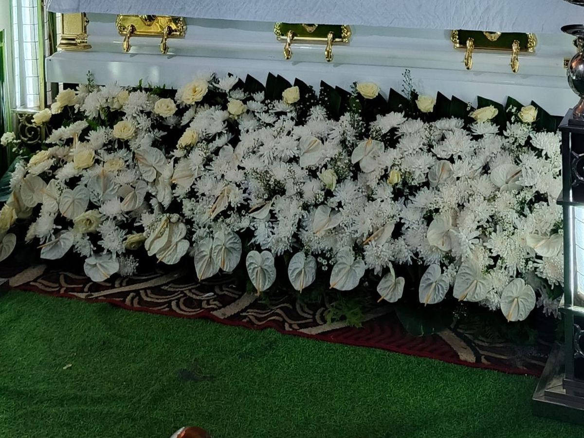White roses, anthuriums and chrysanthemums arranged for a wake